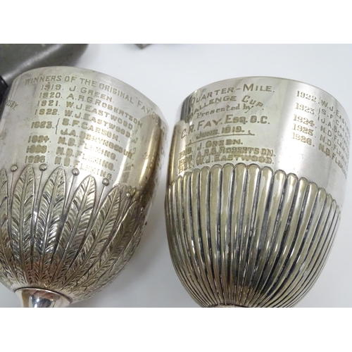 863 - A quantity of assorted silver plate / metal wares to include napkin rings, fish servers, trophy cups... 