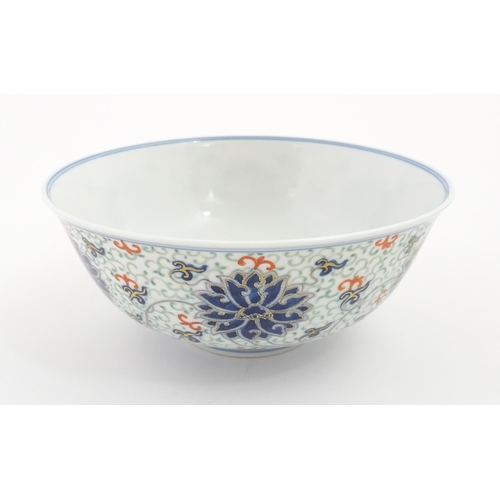 24 - A Chinese bowl decorated with scrolling floral and foliate detail. Character marks under. Approx. 3