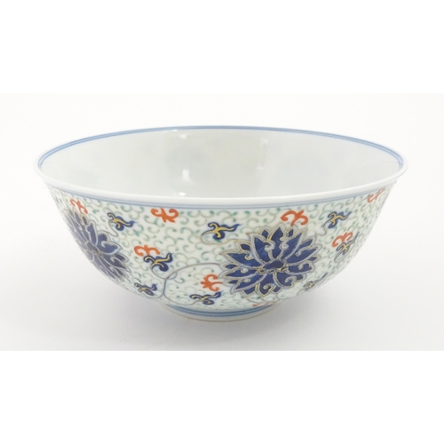 24 - A Chinese bowl decorated with scrolling floral and foliate detail. Character marks under. Approx. 3