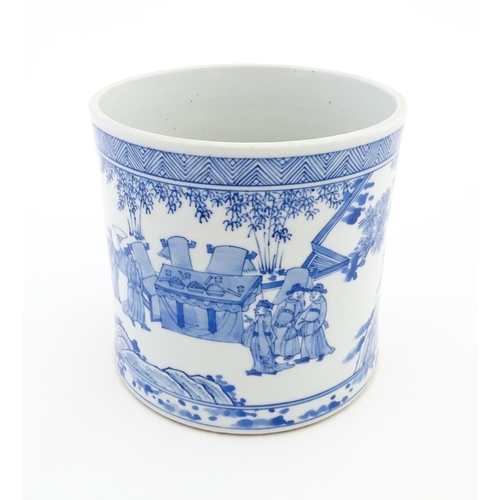 35 - A Chinese blue and white vase / planter decorated with figures in a garden setting with a feast, and... 