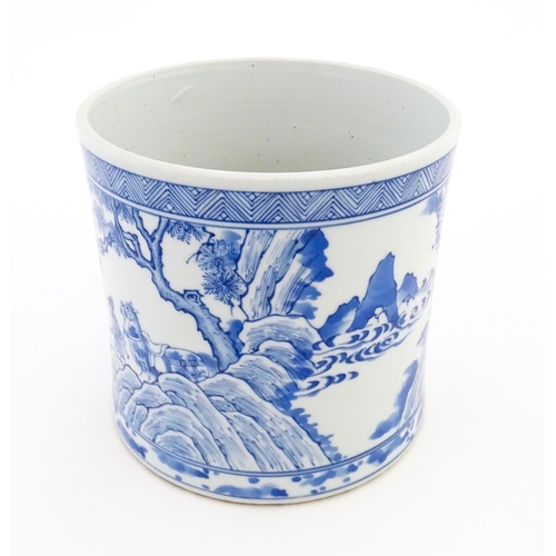 35 - A Chinese blue and white vase / planter decorated with figures in a garden setting with a feast, and... 