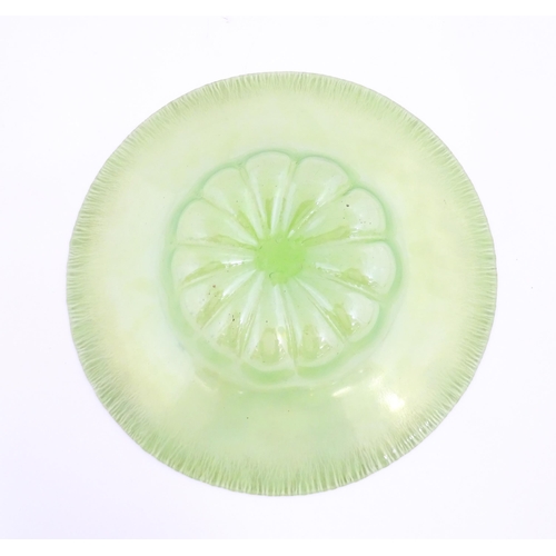 300 - A pale green lustre glass bowl with lobed centre and textured rim. Approx. 12 1/2