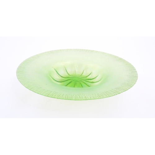 300 - A pale green lustre glass bowl with lobed centre and textured rim. Approx. 12 1/2