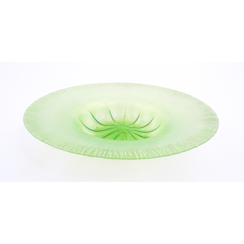 300 - A pale green lustre glass bowl with lobed centre and textured rim. Approx. 12 1/2