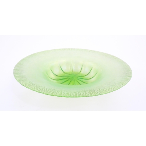 300 - A pale green lustre glass bowl with lobed centre and textured rim. Approx. 12 1/2