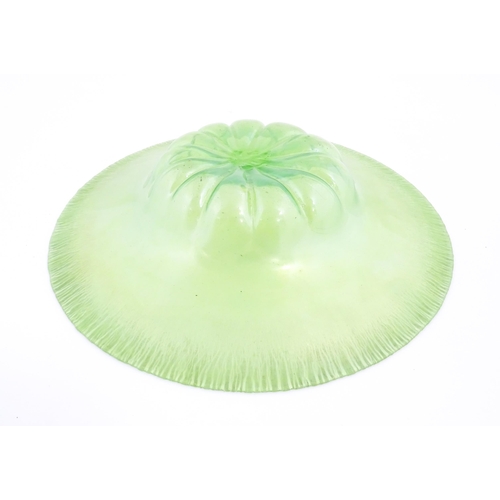 300 - A pale green lustre glass bowl with lobed centre and textured rim. Approx. 12 1/2