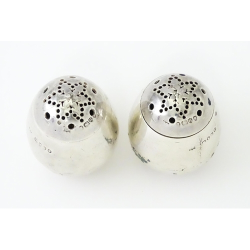 390 - A pair of Victorian silver pepperettes of egg form. Hallmarked London 1883 maker William Hutton & So... 