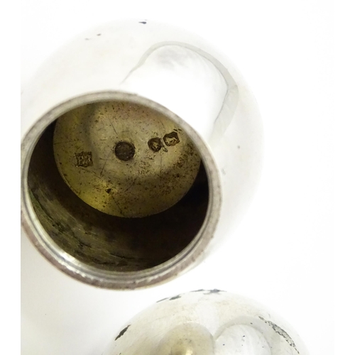390 - A pair of Victorian silver pepperettes of egg form. Hallmarked London 1883 maker William Hutton & So... 