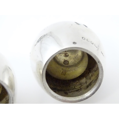 390 - A pair of Victorian silver pepperettes of egg form. Hallmarked London 1883 maker William Hutton & So... 