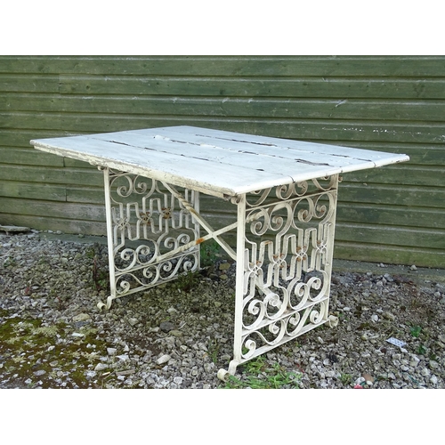 828 - Garden / Architectural: a wrought iron table with painted wooden top, approx 54