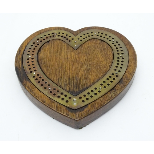 848 - Toy: A Victorian oak and brass cribbage board of heart form. Approx. 7