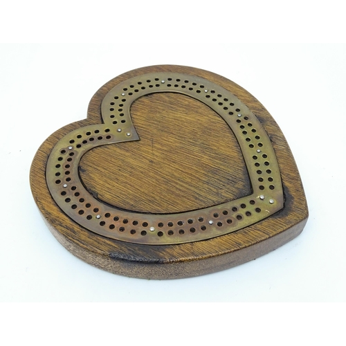 848 - Toy: A Victorian oak and brass cribbage board of heart form. Approx. 7