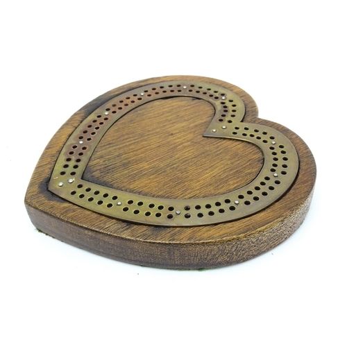 848 - Toy: A Victorian oak and brass cribbage board of heart form. Approx. 7