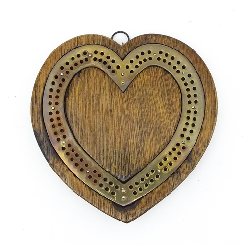 848 - Toy: A Victorian oak and brass cribbage board of heart form. Approx. 7