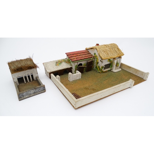 853 - Toys: A 20thC Hugar Models for Britains Ltd. farmyard with three farm outbuildings. Together with a ... 