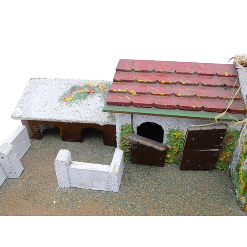 853 - Toys: A 20thC Hugar Models for Britains Ltd. farmyard with three farm outbuildings. Together with a ... 