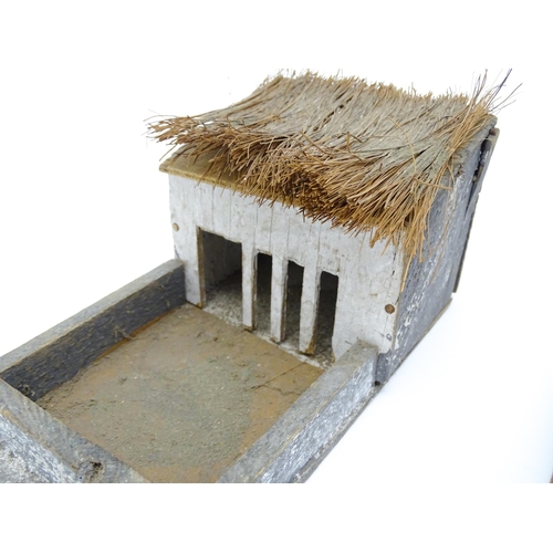 853 - Toys: A 20thC Hugar Models for Britains Ltd. farmyard with three farm outbuildings. Together with a ... 