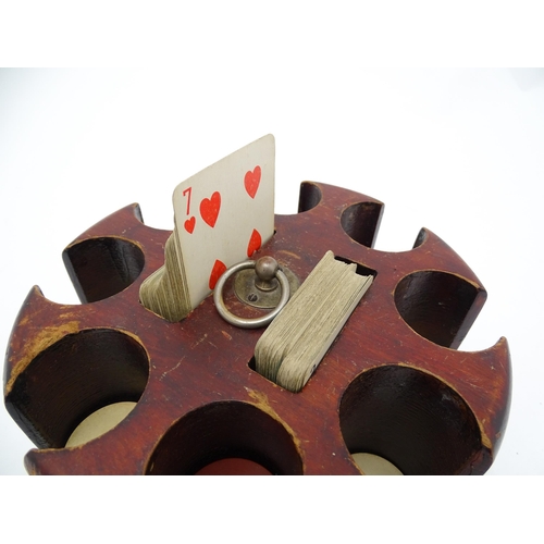 859 - Toys: A 20thC revolving gaming counter /  poker chip stand with two packs of playing cards with clip... 