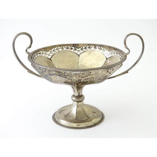 319 - A silver pedestal bon bon dish with twin handles.  Hallmarked Birmingham 1920, maker Mappin & Webb L... 