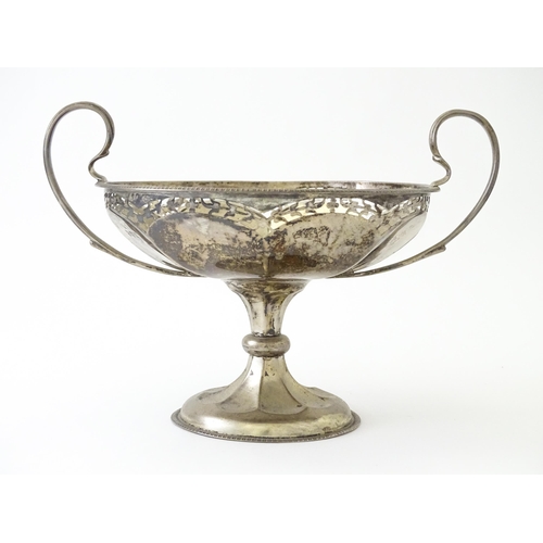 319 - A silver pedestal bon bon dish with twin handles.  Hallmarked Birmingham 1920, maker Mappin & Webb L... 