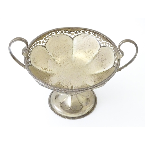 319 - A silver pedestal bon bon dish with twin handles.  Hallmarked Birmingham 1920, maker Mappin & Webb L... 