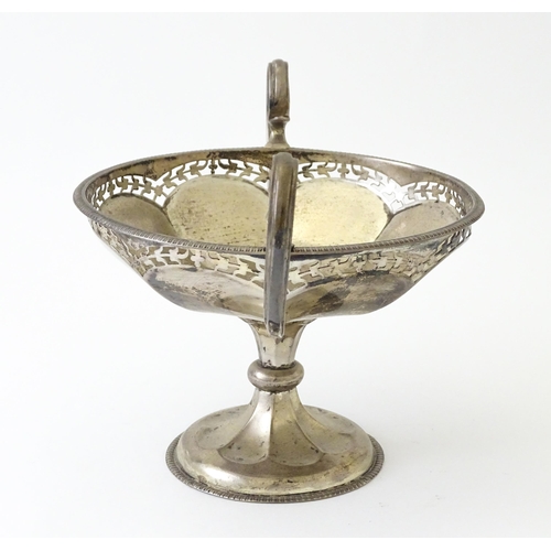319 - A silver pedestal bon bon dish with twin handles.  Hallmarked Birmingham 1920, maker Mappin & Webb L... 
