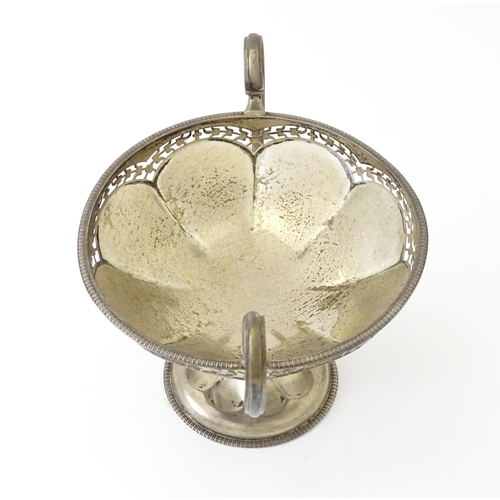 319 - A silver pedestal bon bon dish with twin handles.  Hallmarked Birmingham 1920, maker Mappin & Webb L... 