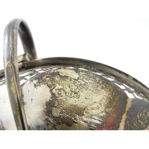 319 - A silver pedestal bon bon dish with twin handles.  Hallmarked Birmingham 1920, maker Mappin & Webb L... 
