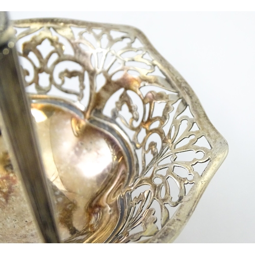 323 - A pedestal silver bon bon dish with swing handle. Hallmarked Birmingham 1912 maker S Blanckensee & S... 