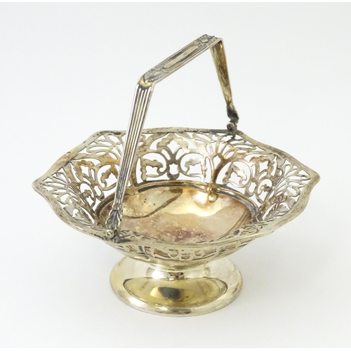 323 - A pedestal silver bon bon dish with swing handle. Hallmarked Birmingham 1912 maker S Blanckensee & S... 