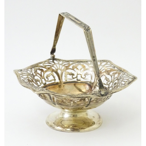 323 - A pedestal silver bon bon dish with swing handle. Hallmarked Birmingham 1912 maker S Blanckensee & S... 