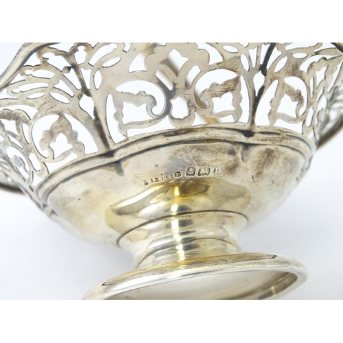 323 - A pedestal silver bon bon dish with swing handle. Hallmarked Birmingham 1912 maker S Blanckensee & S... 