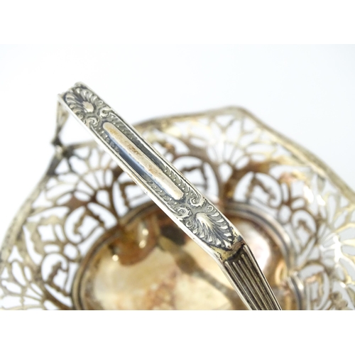 323 - A pedestal silver bon bon dish with swing handle. Hallmarked Birmingham 1912 maker S Blanckensee & S... 
