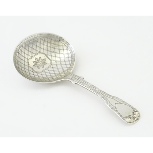 328 - A Geo IV silver caddy spoon with bright cut decoration hallmarked London 1820, maker George Wintle. ... 