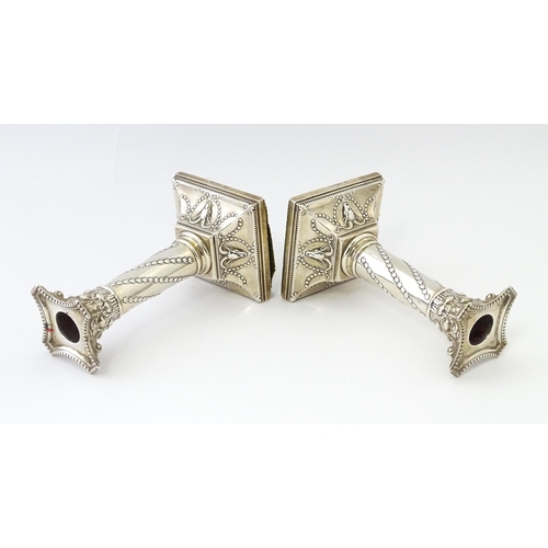 547 - A pair of Edwardian silver candlesticks of column form with swag and rams head detail, hallmarked Lo... 