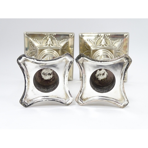 547 - A pair of Edwardian silver candlesticks of column form with swag and rams head detail, hallmarked Lo... 