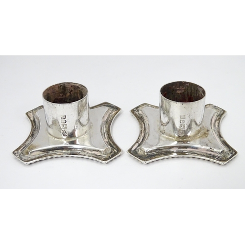 547 - A pair of Edwardian silver candlesticks of column form with swag and rams head detail, hallmarked Lo... 