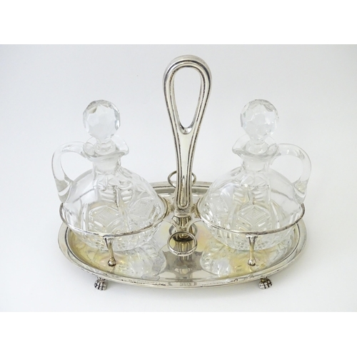 551 - An Italian .800 silver bottle / cruet stand with two glass bottles / jugs of ovoid form. Approx. 7 1... 