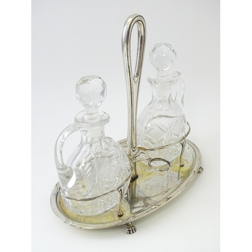 551 - An Italian .800 silver bottle / cruet stand with two glass bottles / jugs of ovoid form. Approx. 7 1... 