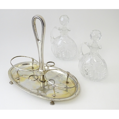 551 - An Italian .800 silver bottle / cruet stand with two glass bottles / jugs of ovoid form. Approx. 7 1... 