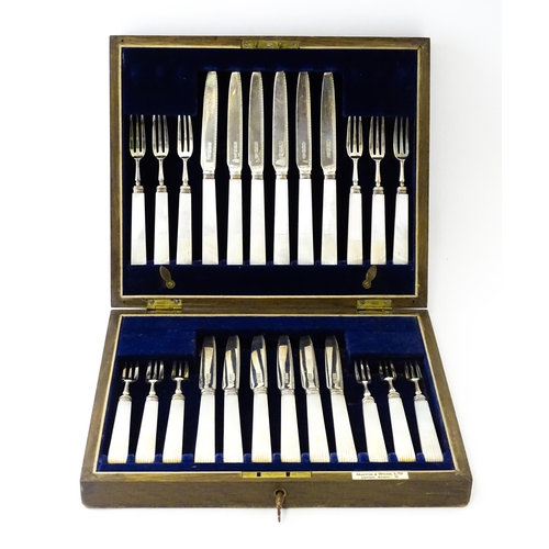 560 - A cased set of twelve silver fruit knives and forks with mother of pearl handles, hallmarked Sheffie... 