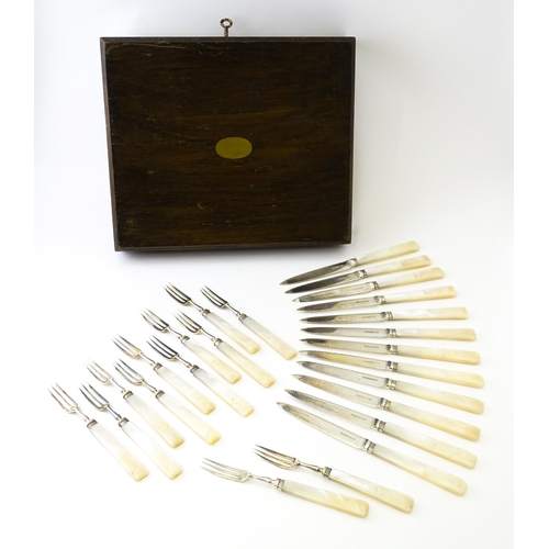 560 - A cased set of twelve silver fruit knives and forks with mother of pearl handles, hallmarked Sheffie... 