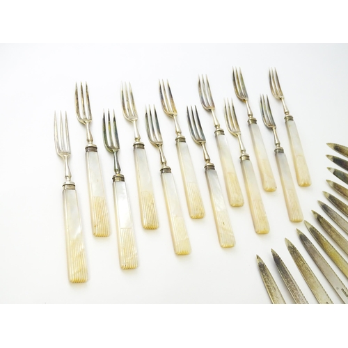 560 - A cased set of twelve silver fruit knives and forks with mother of pearl handles, hallmarked Sheffie... 