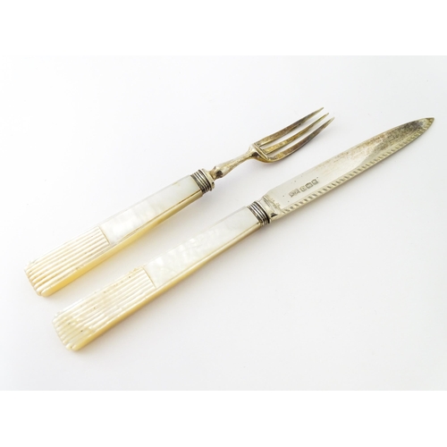 560 - A cased set of twelve silver fruit knives and forks with mother of pearl handles, hallmarked Sheffie... 