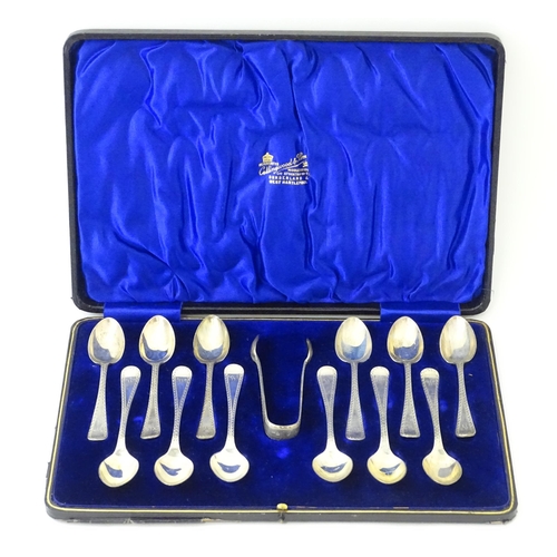 562 - A matched set of twelve silver teaspoons with sugar tongs en suite, hallmarked Sheffield 1905 / 1906... 