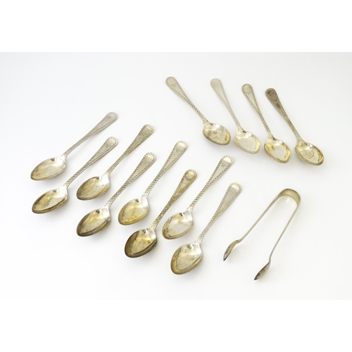 562 - A matched set of twelve silver teaspoons with sugar tongs en suite, hallmarked Sheffield 1905 / 1906... 