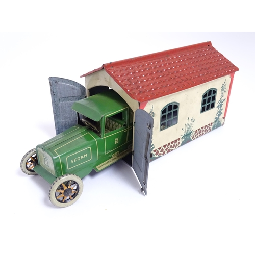 849 - Toys: A Lehmann No. 771 tinplate double door garage with a cream body and green foliage detail, with... 