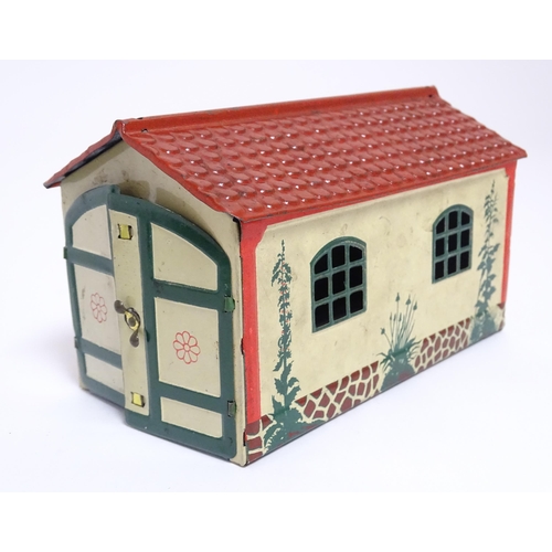 849 - Toys: A Lehmann No. 771 tinplate double door garage with a cream body and green foliage detail, with... 