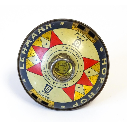 851 - Toys: A Lehmann tinplate Hop-Hop spinning top. Approx. 4