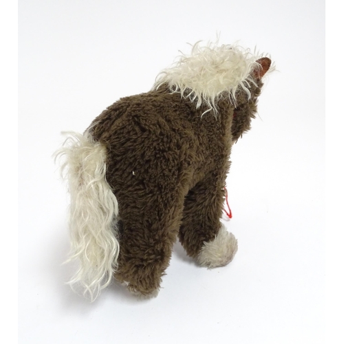 856 - Toy: A 20thC Steiff Cosy Pony, plush horse toy. Approx. 8